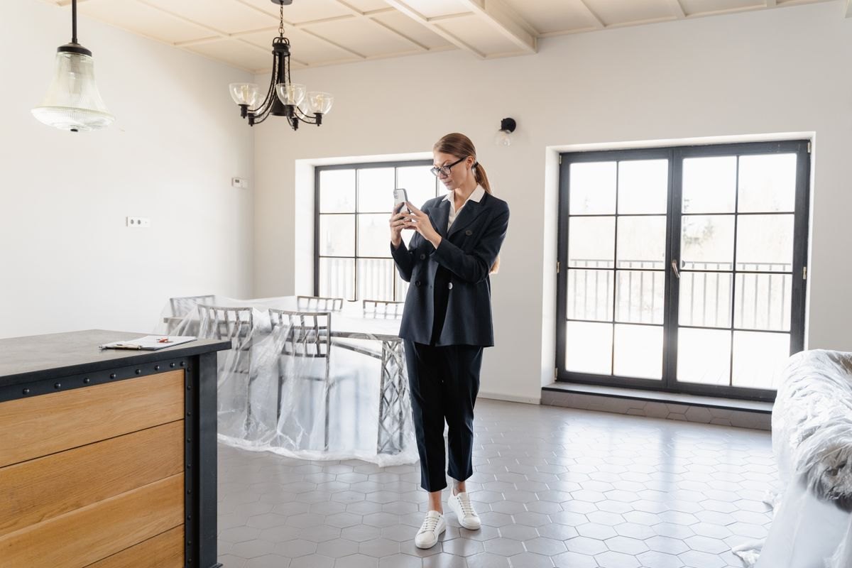 Person documenting a home with a smartphone